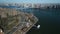 Aerial footage massive steel Williamsburg Bridge spanning East River and urban boroughs on riverbanks. New York City
