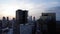 Aerial footage of Mexico City with a view of buildings and sunrise on the right