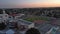 aerial footage of the Monrovia High School with a football field and a baseball field surrounded by homes, lush green trees