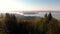 Aerial footage of a mountain viewpoint overlooking West Vancouver and downtown Vancouver at dawn.