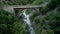 Aerial footage of an old bridge in the mountains over a rocky valley