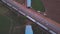 Aerial footage over the railway underpass and a moving train near the cultivated fields