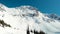 Aerial footage of the peak of Blackcomb mountain on a sunny day.