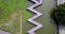 Aerial footage on people walking, passing by on zig-zag styled bridge on the lake.