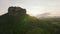 Aerial footage of popular Lions Rock surrounded by tropical green forest. Morning shot against sunrise sky. Sigiriya