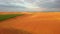 Aerial footage of ripe rapeseed ready for harvest from a bird`s eye view. Filmed in UHD 4k video