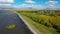 Aerial footage road near lake. Highway traffic near water. Road near Sevan lake in Armenia, Caucasus.