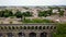 Aerial footage of Saint-ClÃ©ment historical aqueduct and mediterranean city panorama