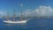 Aerial footage of a ship with raised sails with view of cruise liners and port Bridgetown, Barbados