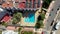 Aerial footage of the Spanish Island of Ibiza in the Balearic islands showing a drone top down view of a hotels swimming pool with