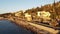 Aerial footage of sunny Puerto de Bordighera coast houses by the sea with boats in Imperia, Italy