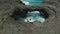 Aerial footage of surge of waves at a rocky coast with clear blue water