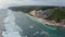 Aerial footage tropical beach and blue sea water with white waves, drone view.