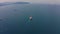 Aerial footage of ultra large container cargo ship leaves port, backside view.