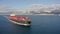 Aerial footage of ultra large container cargo ship at sea, side view.