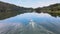 Aerial footage of a white boat going forward on the top of a great lake