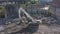 Aerial footage of a white Cat 330D Excavator digger at a construction site