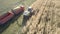 Aerial forage harvester fills truck with cut corn mass