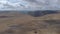 An aerial forward reveal footage of a Scottish summit plateau with huge cliff in the background