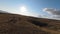 Aerial FPV drone shot of a chasing and flying close around herd of wild horses running on a field at beautiful summer