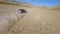 Aerial freestyle view speed riding black SUV automobile on endless sand road desert