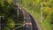 Aerial freight train on a long railroad, top view.