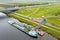 Aerial from freighter unloading sand with the highway A1 in the  background in the countryside from the Netherlands