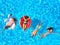 Aerial of friends having party in swimming pool with inflatable flamingo, swan, mattress. Happy young people relax at