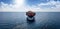 Aerial front view of a container cargo vessel traveling over the ocean