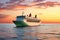 Aerial front view of a heavy crude oil tanker traveling over calm sea during sunset