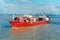 Aerial front view of a loaded container cargo vessel traveling over calm ocean