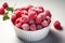 Aerial frost Frozen organic raspberries showcased in a white bowl