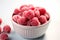 Aerial frost Frozen organic raspberries showcased in a white bowl