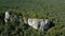 Aerial Of Giant Rocks In Green Forest Highlands