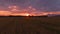 AERIAL: Golden sunset gently illuminates the tranquil farmland in Slovenia.