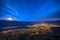 Aerial of Grenoble at night with moon rising over the mountains