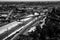 Aerial greyscale shot of the city full of different kinds of buildings