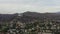 AERIAL: Griffith Observatory far away with view on Hollywood Hills in Daylight, Los Angeles, California, Cloudy