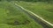 Aerial of a group of bicycle riders along a nature trail in summer