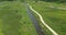 Aerial of a group of bicycle riders along a nature trail in summer