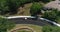 Aerial: A group of girls in bikini ride on a white jeep on the road.