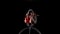 Aerial gymnasts performs a trick on the hoop metal construction. Black background. Slow motion