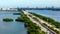 Aerial helicopter or drone tour Miami causeway bridge over water December 2023