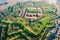 Aerial helicopter view of walls, moats, bastions, earthworks, outworks and barracks of six-star hexagon shaped renaissance fort