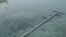 Aerial High angle view drone shot of long bridge in to the tropical sea.