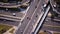 Aerial high drone flight over road traffic. Highway and overpass with cars and trucks, interchange, two-level road junction in the