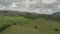 Aerial hilly rural landscape view with large green valleys and dramatic sky