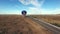 Aerial hot air balloon landing by busy road in desert