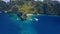 Aerial hover view of trip boats moored on diving spot near secret lagoon on Miniloc Island. El-Nido, Palawan