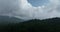 Aerial hyperlapse timelapse aerial view of clouds and mountains with green forest